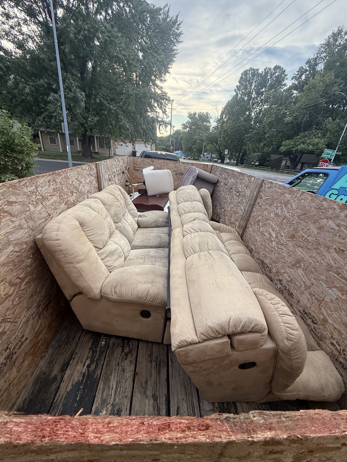 Couch loaded into an Adonai Junk Removal trailer
