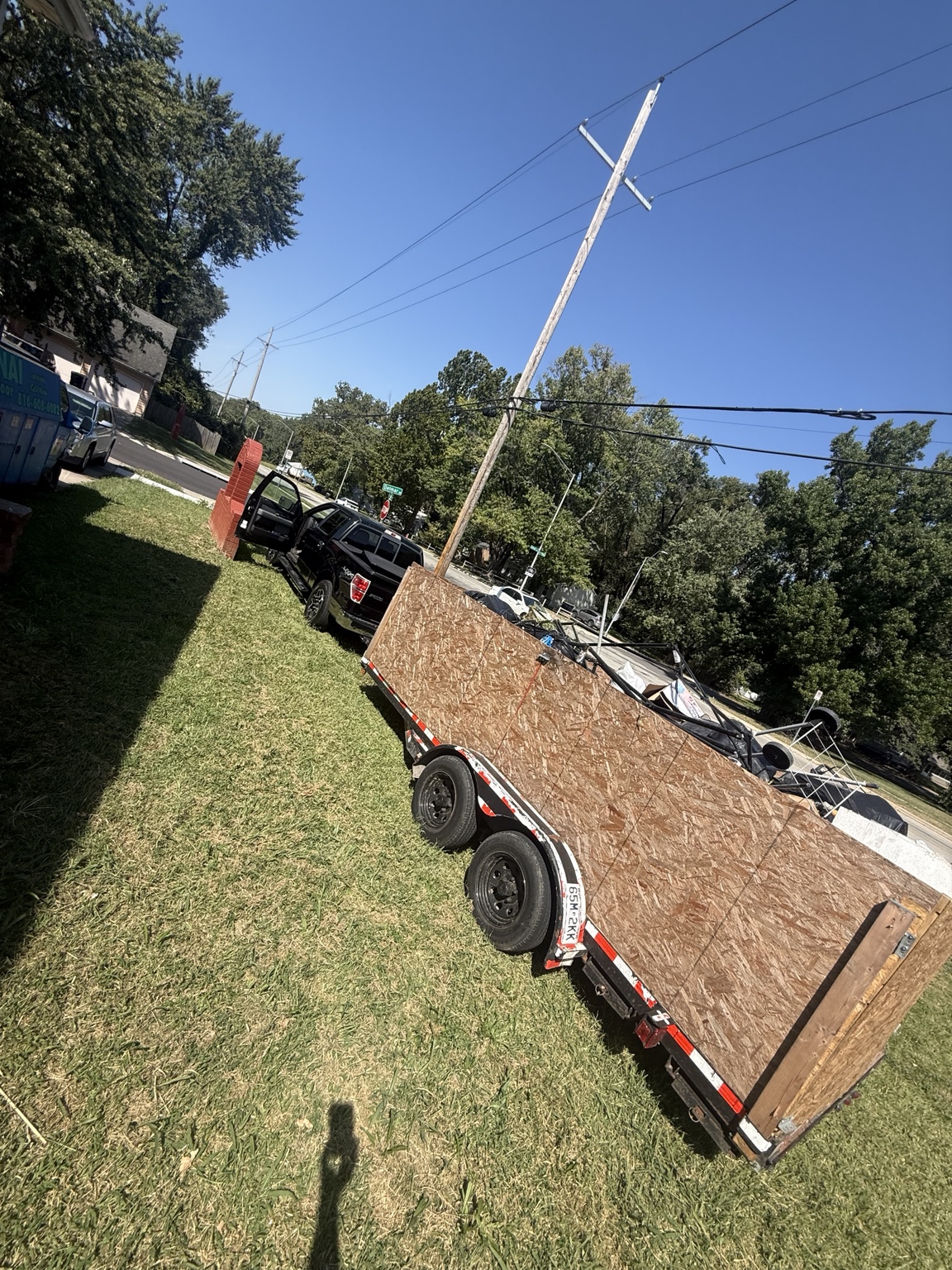 Adonai Junk Removal trailer at a completed job