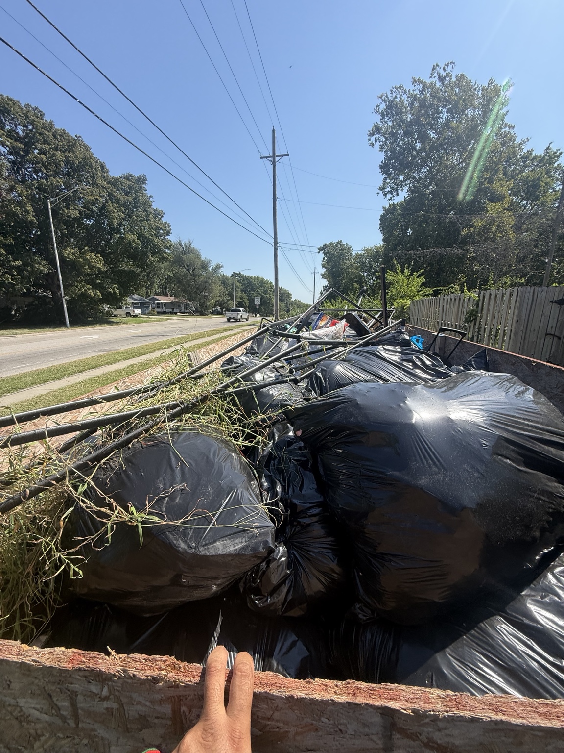 Bagged yard debris loaded into a junk removal trailer